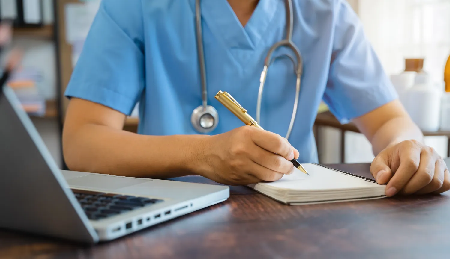 male doctor working on desk with laptop computer a utc